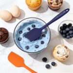 A complete 5-piece AUWUB navy blue silicone kitchen utensil set, including spatulas and spoons, displayed neatly.