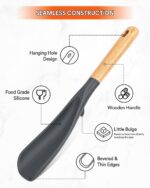 Two Badiano silicone cooking spoons, one black and one grey, with wooden handles, resting on a clean surface.
