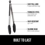 Two cooking tongs, one 7-inch and one 9-inch, with brushed stainless steel handles and black silicone tips, in a kitchen sett