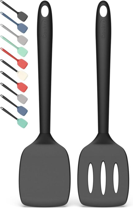 Two PureBlack silicone spatulas, one solid and one slotted, lying on a clean kitchen surface, ready for cooking.