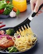 Close-up of a black silicone pasta tong and a polished stainless steel spaghetti spoon with teeth
