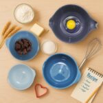 A set of four blue Glad plastic mixing bowls with pour spouts and handles, nested together on a white background.