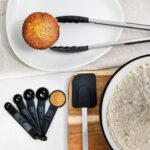 A complete set of 41 Home Hero stainless steel and black silicone kitchen utensils, including measuring cups and spoons.