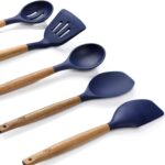 Five midnight blue silicone kitchen utensils with natural acacia wood handles, including a spoon, spoonula, spatula, turner,