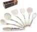 A set of white silicone cooking utensils with stainless steel handles, including a spatula, ladle, spoon, whisk, and tongs.