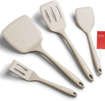 A set of four khaki silicone spatulas of varying sizes, including a slotted and a pancake spatula, on a neutral background.
