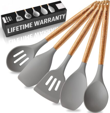 A complete set of five grey silicone cooking utensils with light brown acacia wood handles, arranged neatly.